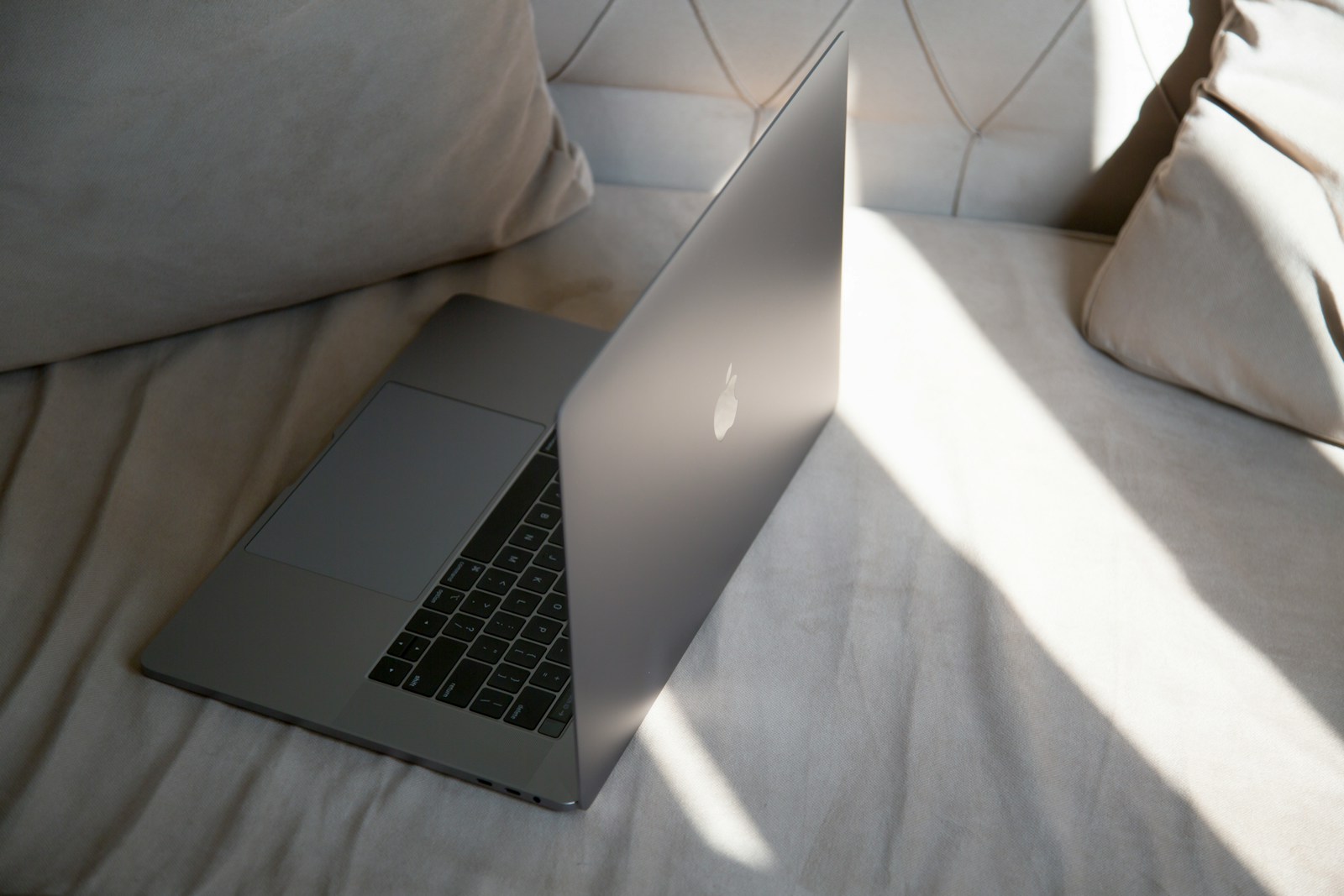 a laptop computer sitting on top of a bed